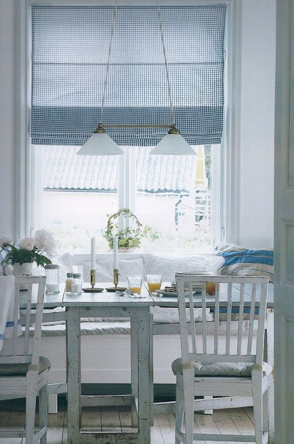 Pastels, white furniture, and built-in banquette in Swedish style kitchen - found on Hello Lovely Studio