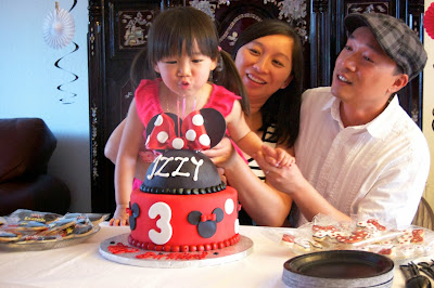 Izzy blowing out birthday cake