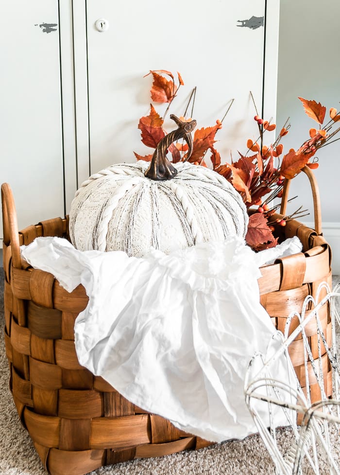 textured white pumpkin, basket, ruffled throw, fall stems