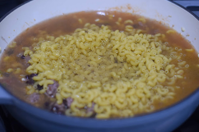 The water and chicken broth added to the dutch oven.