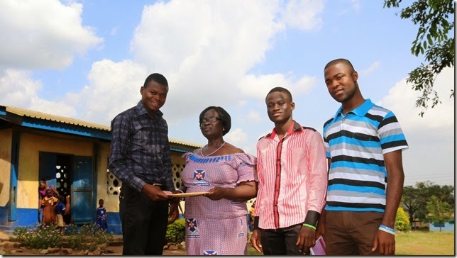 Adams hands Student Checks to Auntie Margaret