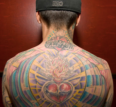 Sacred heart tattoo on the back.