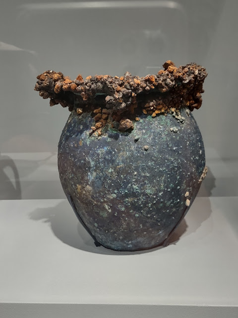 Metal vase, encrusted with something, from Pompeii