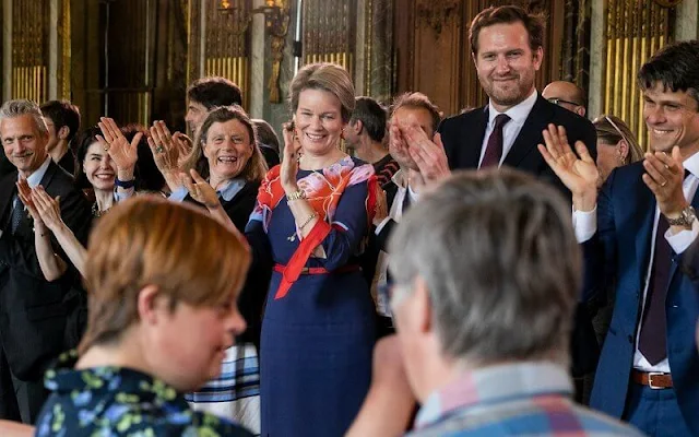 Queen Mathilde wore a navy floral-print silk-faille maxi wrap dress by Etro, and red orange pumps by Natan