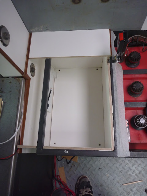 The false bottom, covering the Pyle 24v amplifier.