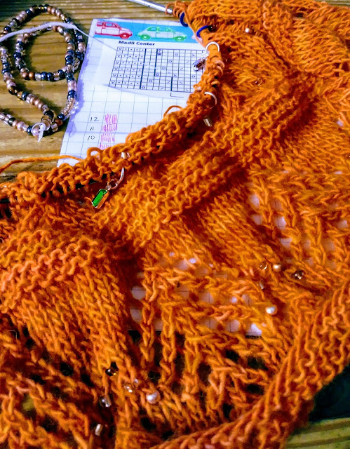 I'm knitting a beaded, estonian lace shawl with Malabrigo lace weight yarn.  I'm replacing the knups with beads.