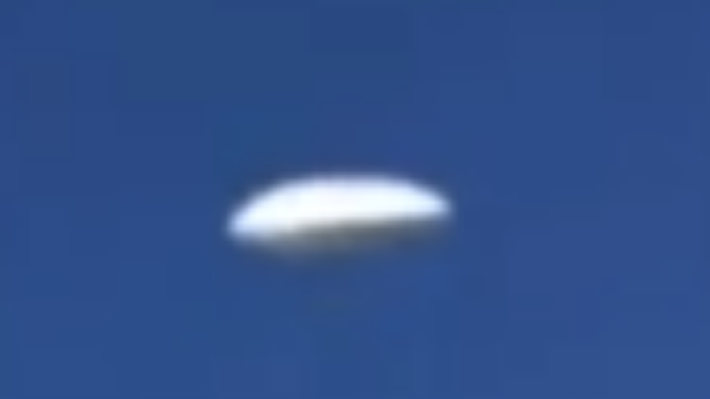 Amazing looking white UFO filmed from a plane over the United States.