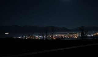 Night time reveals smoke over the local town