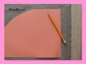 Tracing the construction paper cone template.