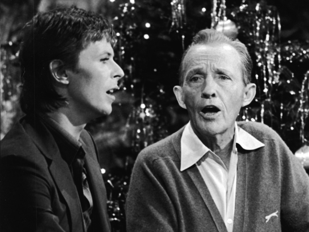 David Bowie and Bing Crosby singing together in front of Christmas tree