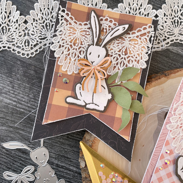 Easter Bunny Banners created with: Tim Holtz bunny stitch, bloom colorize die; Scrapbook.com nested flag banner, bow toppers, harvest, boho, roses paper; Pinkfresh jewels; Reneabouquets lace
