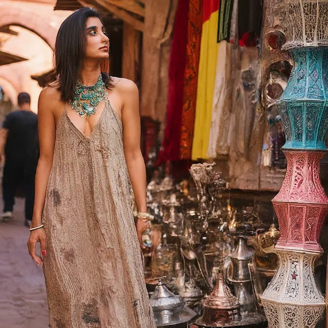 A South Asian woman in a flowy maxi dress