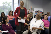 A woman stands to address a meeting