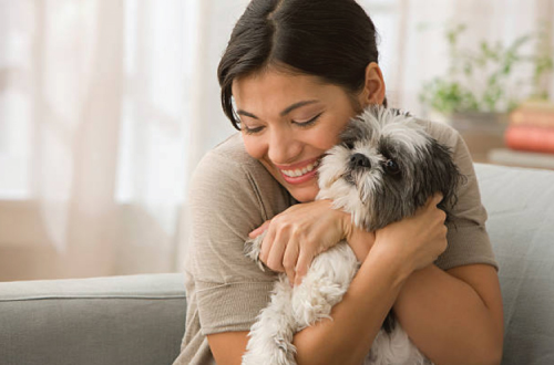 woman hugging dog