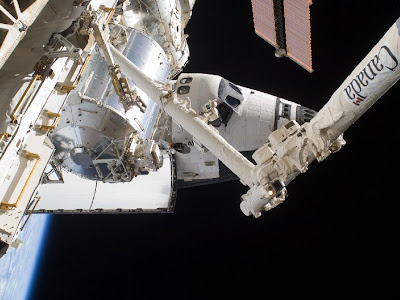 A partial view of the space shuttle Atlantis docked to the International Space Station