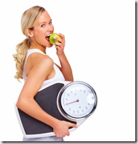 Young girl eating apple and carrying set of scales