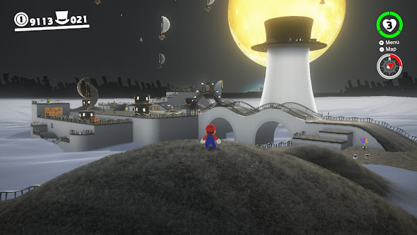 Super Mario Odyssey screen shot - Mario stands on a grey hill looking over a town made of hat shapped buildings, including a large hat on a tower. The moon rises bright and yellow behind the tower.