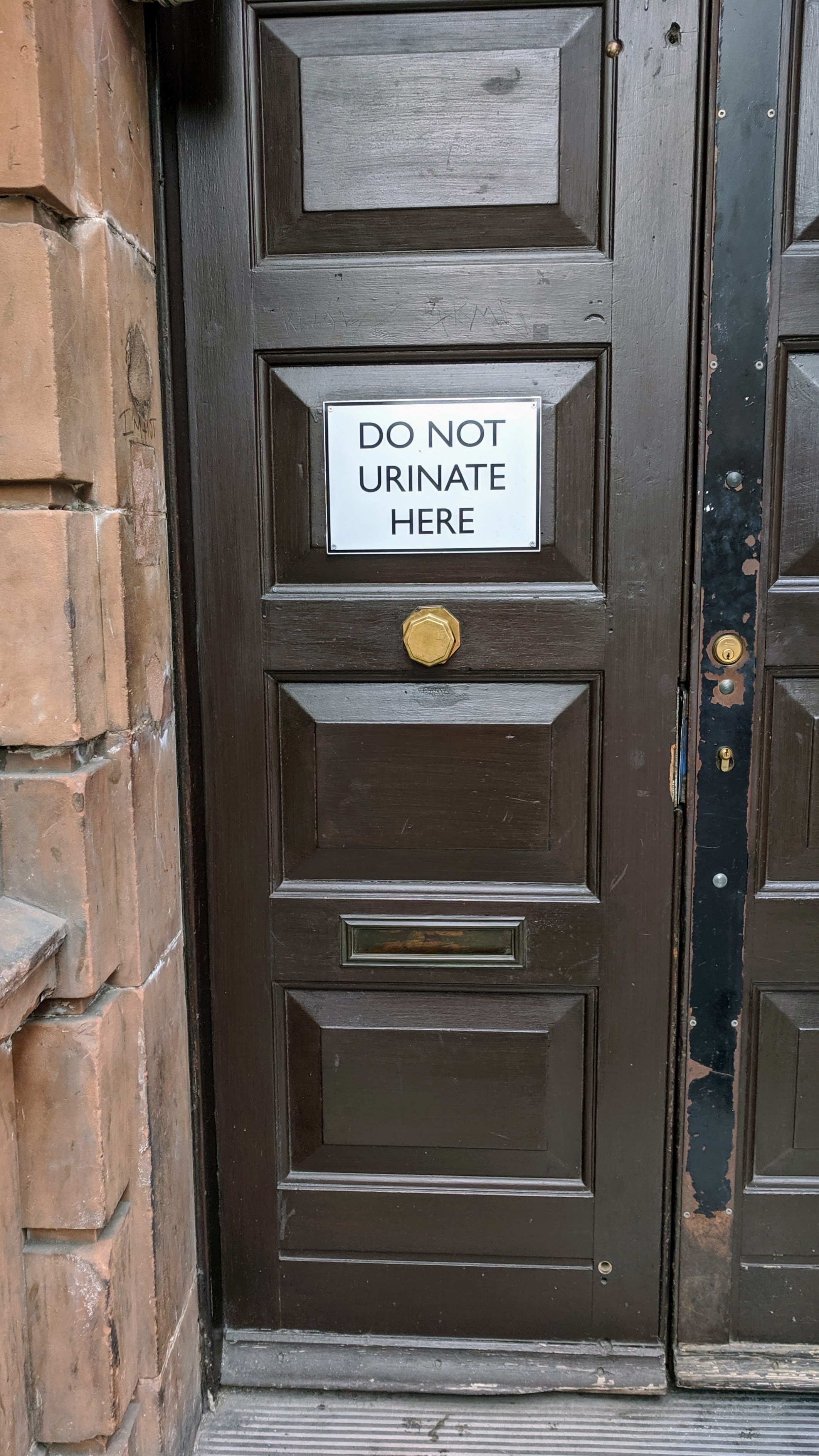 'Do Not Urinate Here' door sign