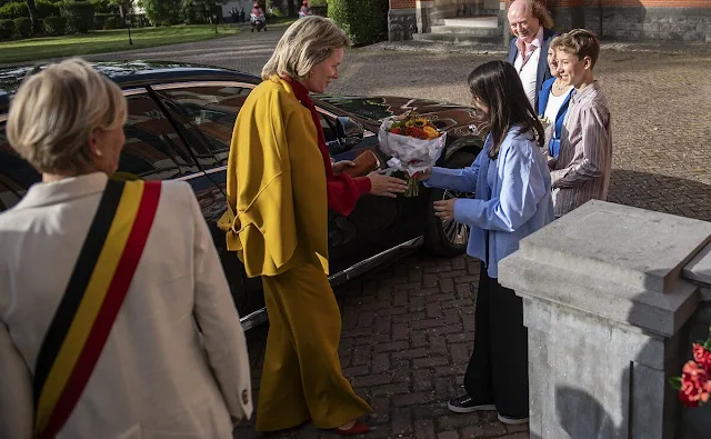 Queen Mathilde wore a McDonalds outfit by Natan couture, Natan iris coat. Cambridge International School