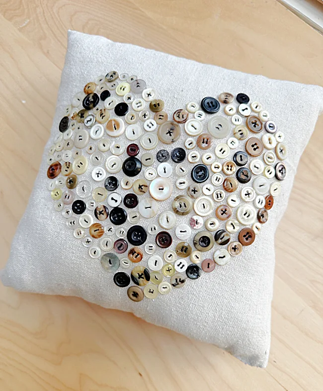 small pillow with heart button design