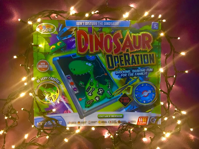 A Dinosaur Operation game surrounded by fairy lights