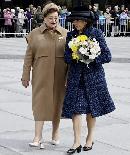 Queen Silvia wore a navy tweed coat, tweed jacket and navy tweed dress by Chanel. Mrs Sirje Karis and Prime Minister Kaja Kallas