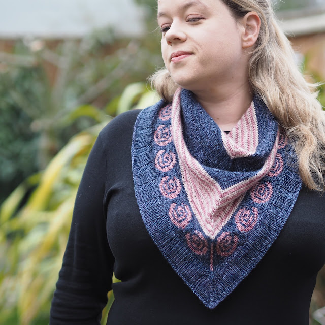 woman wearing navy, pink and cream bandana cowl with pink stranded roses