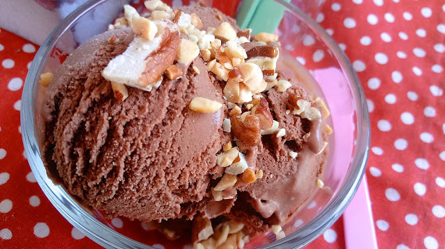 a close up of a scoop of Chocolaty Chocolate Dairy Free Ice Cream in a glass dish on a red and white polk a dot cloth