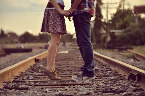 couples on train tracks