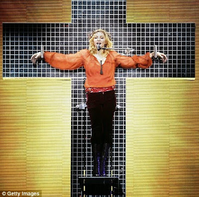 Madonna in her controversial singing in a cross