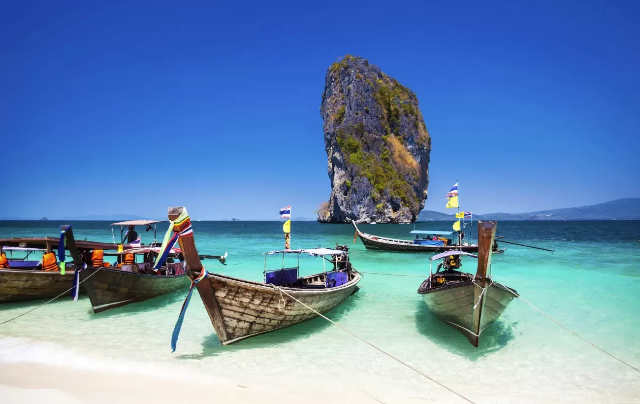"Discover the Best of Thailand: A Travel Guide to Paradise" Thailand is a popular destination for tourists from around the world. Known for its beautiful beaches, historic sites, delicious food and friendly locals, it's no wonder why so many people choose to travel to this Southeast Asian country. Here are some key points to consider when planning your next trip to Thailand.    ## Beaches   Thailand is famous for its stunning beaches that attract visitors from all over the globe. From Phuket and Krabi in the south to Koh Samui and Pattaya on the east coast , there are plenty of options when it comes to finding your perfect beach getaway. Whether you're looking for secluded coves or bustling party scenes, Thailand has something for everyone.    ## Culture    Thailand has a rich cultural heritage with ancient temples and palaces scattered throughout the country.These historical sites offer an insight into Thai history & religion .One must definitely visit Grand Palace & Wat Phra Kaew in Bangkok as they play important role in Thai monarchy .    ## Food    Thai cuisine is renowned across world thanks to its unique blend of sweet,sour,salty & spicy flavors.From street side vendors selling Pad Thai (Stir Fried Noodles) & Som Tam(Papaya Salad)to fine dining restaurants serving Massaman Curry,Crispy Pork Belly etc., one can never get enough of these dishes during their stay in Thailand .    ## Nightlife    When night falls,Thailand truly comes alive with vibrant nightlife scene catering every taste from bars playing live music ,nightclubs blasting bass-heavy beats till dawn,Khaosan Road which offers backpackers cheap drinks along with street performers showcasing their talent making every moment memorable.    ## Shopping   Shopping enthusiasts will be spoilt for choice as Thailand has everything from traditional markets like Chatuchak Weekend Market offering wide range products at cheap prices  ,luxury shopping malls such as Siam Paragon giving high-end brands experience alongside local designer boutiques located around Sukhumvit area.    Overall, Thailand is a destination that offers something for everyone. Whether you're looking to relax on the beach, explore ancient temples or indulge in delicious food and exciting nightlife, this country has it all. So pack your bags and get ready for an adventure in the land of smiles!