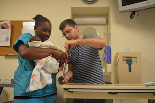 Nurse and father getting baby's footprint