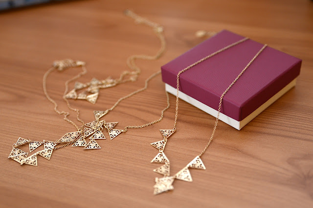 Gold minimalist necklaces and a jewelry box