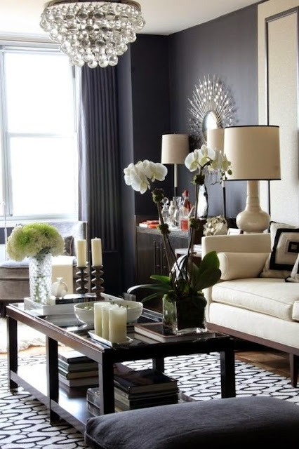 black living room walls robert abbey crystal chandelier white sofa sunburst mirror
