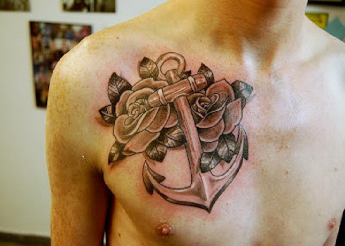 Big anchor with roses tattoo on chest