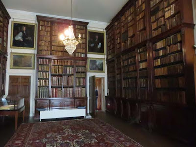 library with tall bookcases and carpet