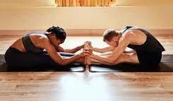 man woman doing yoga poses