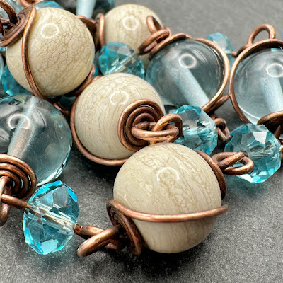 Handmade lampwork glass and copper wirework necklace by Laura Sparling