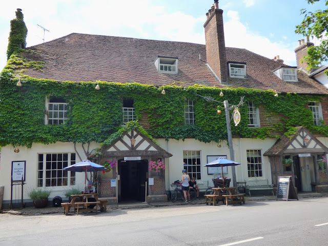The Leicester Arms pub in Penshurst village, an old fashioned building with tiled roof and top floor covered in ivy.