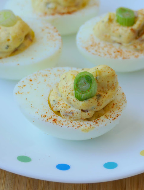 Easy Bacon Deviled Eggs Recipe! Look no further for your new favorite game day, party or holiday appetizer! This easy recipe is full of delicious bacon, basil, garlic and more!