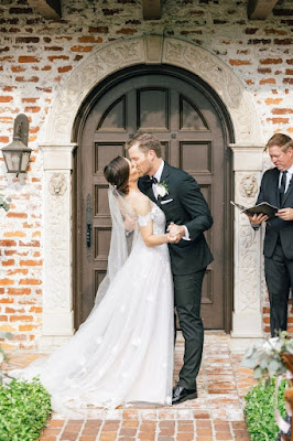 bride and groom kissing at ceremony