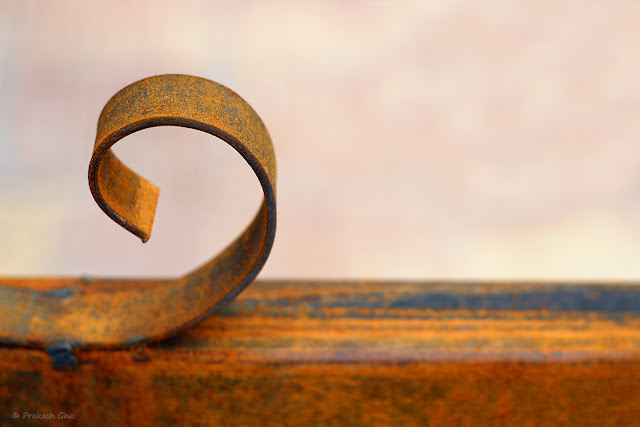 A Minimalistic Photograph of Curved Rusted Metal shot via Canon 600D DSLR Camera.