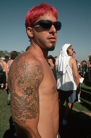 Dragon Tattoo Black flaming dragon tattoo on sun glassed man's arm
