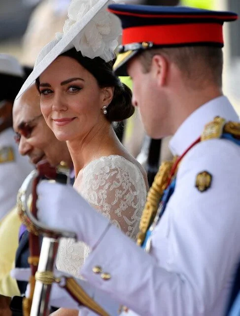 Kate Middleton wore a white lace dress by Alexander McQueen. Anya Hindmarch pearl-embellished satin clutch