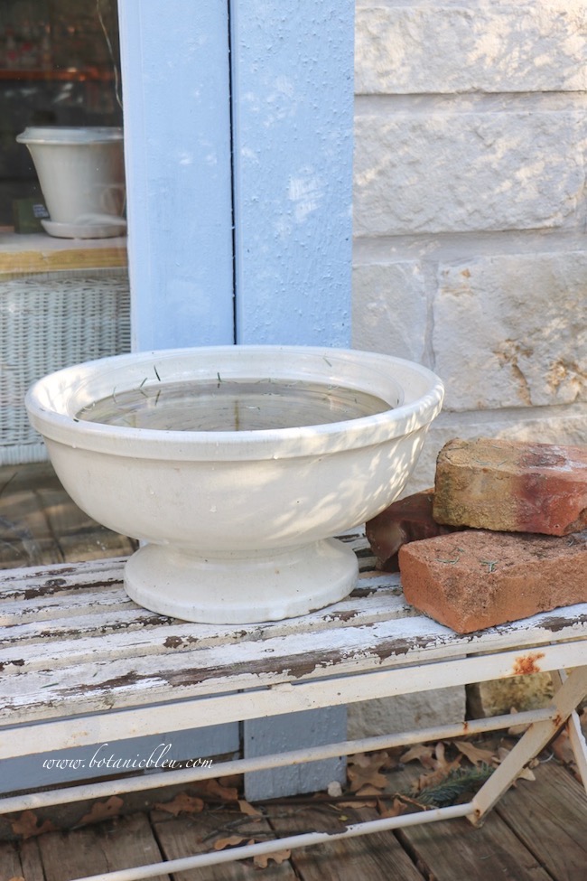 Add antique bricks beside the urn holding the best ever Christmas greenery idea for a fresh wreath