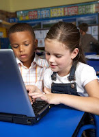 two children playing on the computer