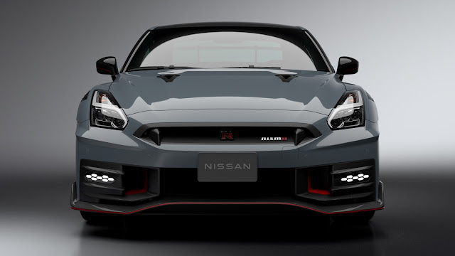 2024 Nissan GT-R NISMO - front view. The front grille has thinner mesh for better cooling and to reduce drag. The air openings are larger than on the 2024 GT-R T-Spec. Also the front lip is different and the 2024 Nissan GT-R NISMO version has canards on both sides of the bottom parts of the front bumper.