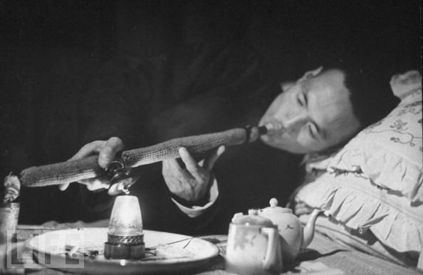 a smoker in a den in China in 1946.jpg