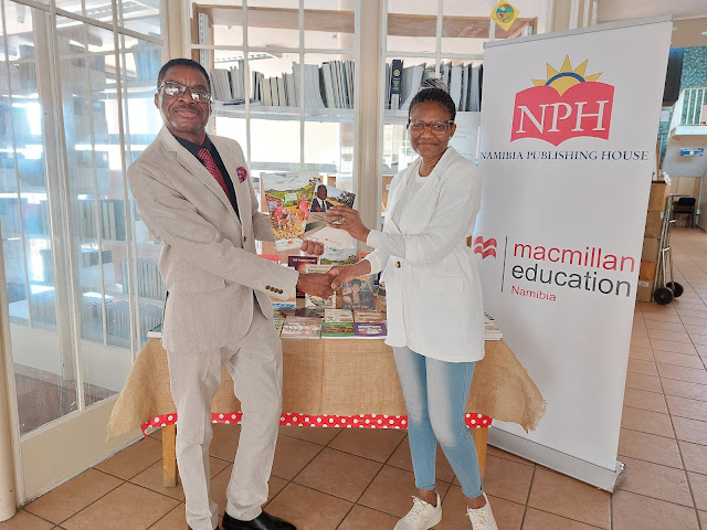 Freddy Nafuka from NPH handing over donated books to Ruth von Plato, Windhoek Public Library