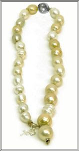 'classic' string of South Sea Pearls accented with one black tahitian